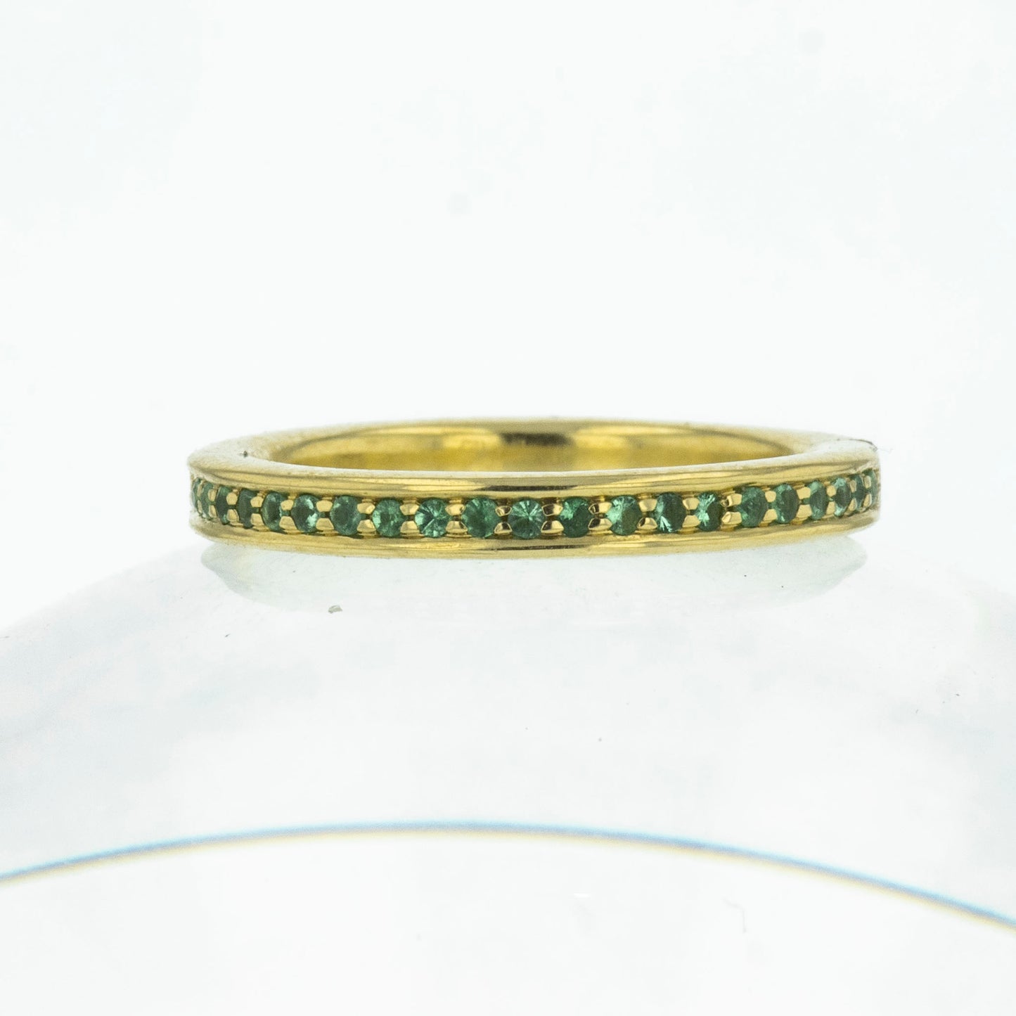 Eternity ring with emerald